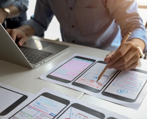 Close up view of UI graphic designer planing his smartphone template