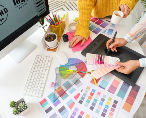 Graphic designer with colleague working in office