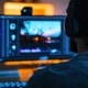 A person editing video while wearing headphones at the desk